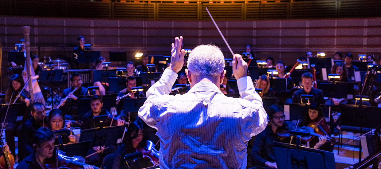 Conductor directs the orchestra at the University of Miami